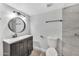 Modern bathroom featuring a sleek vanity, dark fixtures, and stylish tile in the shower at 17211 N 35Th Ave, Phoenix, AZ 85053