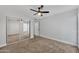 Inviting bedroom features a ceiling fan, carpeted floor and mirrored closet at 17211 N 35Th Ave, Phoenix, AZ 85053