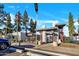 Community entrance with metal and stone facade, American flag, and manicured landscaping under a bright blue sky at 17211 N 35Th Ave, Phoenix, AZ 85053