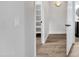 Hallway featuring light fixtures, a small closet, and luxury vinyl plank flooring at 17211 N 35Th Ave, Phoenix, AZ 85053