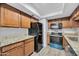 Well-equipped kitchen featuring stainless steel appliances, granite countertops, and ample cabinet space for storage at 17211 N 35Th Ave, Phoenix, AZ 85053