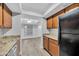 A well-lit kitchen featuring granite countertops, stainless steel appliances, and wood-toned cabinets at 17211 N 35Th Ave, Phoenix, AZ 85053