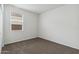 A bedroom with neutral carpet and a window with horizontal blinds at 1768 W Storia Ave, Apache Junction, AZ 85120