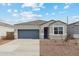 An exterior elevation of a one-story home with a two-car garage at 1768 W Storia Ave, Apache Junction, AZ 85120