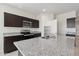 Close-up of kitchen island with granite countertops and stainless steel appliances at 1768 W Storia Ave, Apache Junction, AZ 85120