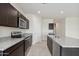 Dark cabinetry and stainless steel appliances complement the granite countertops at 1768 W Storia Ave, Apache Junction, AZ 85120