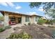 Charming home exterior featuring a covered patio and low-maintenance desert landscaping at 17963 E Silver Sage Ln, Rio Verde, AZ 85263