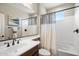 Bathroom features a large mirror, bathtub with shower, and vanity with dark wood cabinets at 17963 E Silver Sage Ln, Rio Verde, AZ 85263