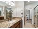 Bathroom boasts a granite countertop, framed mirror, walk-in shower, and walk-in closet at 17963 E Silver Sage Ln, Rio Verde, AZ 85263