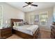 Cozy bedroom featuring a king bed, ceiling fan, and natural light from bright windows at 17963 E Silver Sage Ln, Rio Verde, AZ 85263