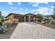 A charming single-story home with a paved driveway, desert landscaping, and a two-car garage at 17963 E Silver Sage Ln, Rio Verde, AZ 85263