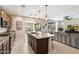 A view of the kitchen with a large center island and stainless steel appliances, open to the living area at 17963 E Silver Sage Ln, Rio Verde, AZ 85263