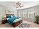 Relax in this main bedroom featuring a king bed, ceiling fan, plush rug, and bright windows at 17963 E Silver Sage Ln, Rio Verde, AZ 85263