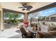 Relaxing covered patio with comfortable seating, ceiling fan, and serene outdoor views at 17963 E Silver Sage Ln, Rio Verde, AZ 85263