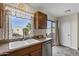 Cozy kitchen area featuring a double basin sink and stainless steel dishwasher at 1992 E Shetland Dr, San Tan Valley, AZ 85140