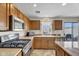 Modern kitchen featuring stainless steel appliances and wooden cabinetry at 1992 E Shetland Dr, San Tan Valley, AZ 85140