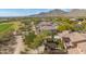 Aerial perspective reveals desert landscape, golf course, and tiled-roof homes with private backyards at 20785 W Canyon Dr, Buckeye, AZ 85396