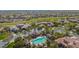 Expansive aerial shot showcasing a community pool, palm trees, golf course, and residential homes at 20785 W Canyon Dr, Buckeye, AZ 85396