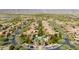 Community aerial view showcasing the neighborhood pool, lush landscaping, and well-maintained streets at 20785 W Canyon Dr, Buckeye, AZ 85396