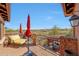 Balcony with mountain views, a comfortable lounge chair, and an umbrella at 20785 W Canyon Dr, Buckeye, AZ 85396