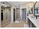 Bathroom featuring stylish fixtures, a walk-in shower, and decorative tile flooring at 20785 W Canyon Dr, Buckeye, AZ 85396