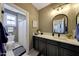 Well-lit bathroom featuring modern vanity, stylish mirror, and separate toilet room at 20785 W Canyon Dr, Buckeye, AZ 85396