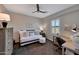 Cozy bedroom with carpet floors, ceiling fan, desk, and lots of natural light at 20785 W Canyon Dr, Buckeye, AZ 85396