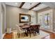 Elegant dining room featuring a wooden table, stylish chandelier, and access to outdoor living space at 20785 W Canyon Dr, Buckeye, AZ 85396