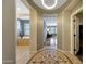 Grand foyer showcasing a decorative tile mosaic and arched openings into the home's interior at 20785 W Canyon Dr, Buckeye, AZ 85396