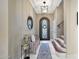 Elegant foyer showcasing a decorative front door, staircase, stylish lighting, and bench seating at 20785 W Canyon Dr, Buckeye, AZ 85396