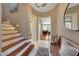 Bright foyer showcasing a staircase, stylish decor, and an inviting view into the living area at 20785 W Canyon Dr, Buckeye, AZ 85396