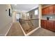 Elegant hallway with wrought iron railing, leading to various rooms within the home at 20785 W Canyon Dr, Buckeye, AZ 85396