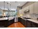 Kitchen featuring a large farmhouse sink, stainless steel appliances, and stone countertops at 20785 W Canyon Dr, Buckeye, AZ 85396