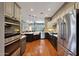 Bright kitchen with stainless steel appliances, wood floors, and an adjacent living space at 20785 W Canyon Dr, Buckeye, AZ 85396