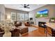 Open-concept living room featuring a fireplace, large windows, and hardwood floors at 20785 W Canyon Dr, Buckeye, AZ 85396