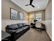 A comfortable home office featuring a black leather sofa, a desk, and a ceiling fan for a productive workspace at 20785 W Canyon Dr, Buckeye, AZ 85396