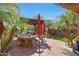 Outdoor kitchen featuring stone counters, bar seating, and a charming pergola at 20785 W Canyon Dr, Buckeye, AZ 85396