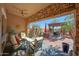 Inviting covered patio featuring stone archway, a ceiling fan, and an outdoor kitchen at 20785 W Canyon Dr, Buckeye, AZ 85396