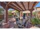 Backyard with an outdoor kitchen under a pergola, fire pit, and paver patio at 20785 W Canyon Dr, Buckeye, AZ 85396