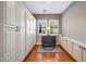 Storage room featuring custom built in cabinets, hardwood floors, and natural light at 20785 W Canyon Dr, Buckeye, AZ 85396