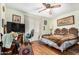 A bedroom with light green walls, a ceiling fan, and shuttered windows at 238 N 62Nd St, Mesa, AZ 85205