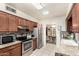 A view of the kitchen showcasing stainless steel appliances and tile backsplash at 238 N 62Nd St, Mesa, AZ 85205