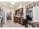 Kitchen with granite countertops, a stainless steel refrigerator, and dark brown cabinets at 238 N 62Nd St, Mesa, AZ 85205