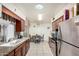 Kitchen featuring stainless steel refrigerator, a large sink, and tile flooring at 238 N 62Nd St, Mesa, AZ 85205