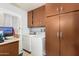 Functional laundry room with washer, dryer, and ample storage cabinets at 238 N 62Nd St, Mesa, AZ 85205