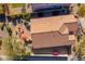 Overhead shot of backyard with outdoor fireplace and red umbrella at 25609 N 54Th Ln, Phoenix, AZ 85083