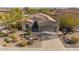 Aerial view of Southwestern home with desert landscaping and a tile roof at 25609 N 54Th Ln, Phoenix, AZ 85083