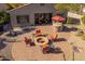 Backyard patio with firepit, seating, outdoor kitchen, and desert landscaping at 25609 N 54Th Ln, Phoenix, AZ 85083