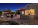 Evening view of the professionally landscaped backyard, with fire pit and outdoor kitchen at 25609 N 54Th Ln, Phoenix, AZ 85083