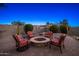 Backyard featuring a charming brick patio with a cozy fire pit and seating at 25609 N 54Th Ln, Phoenix, AZ 85083